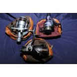 Three cased spinning reels including a S