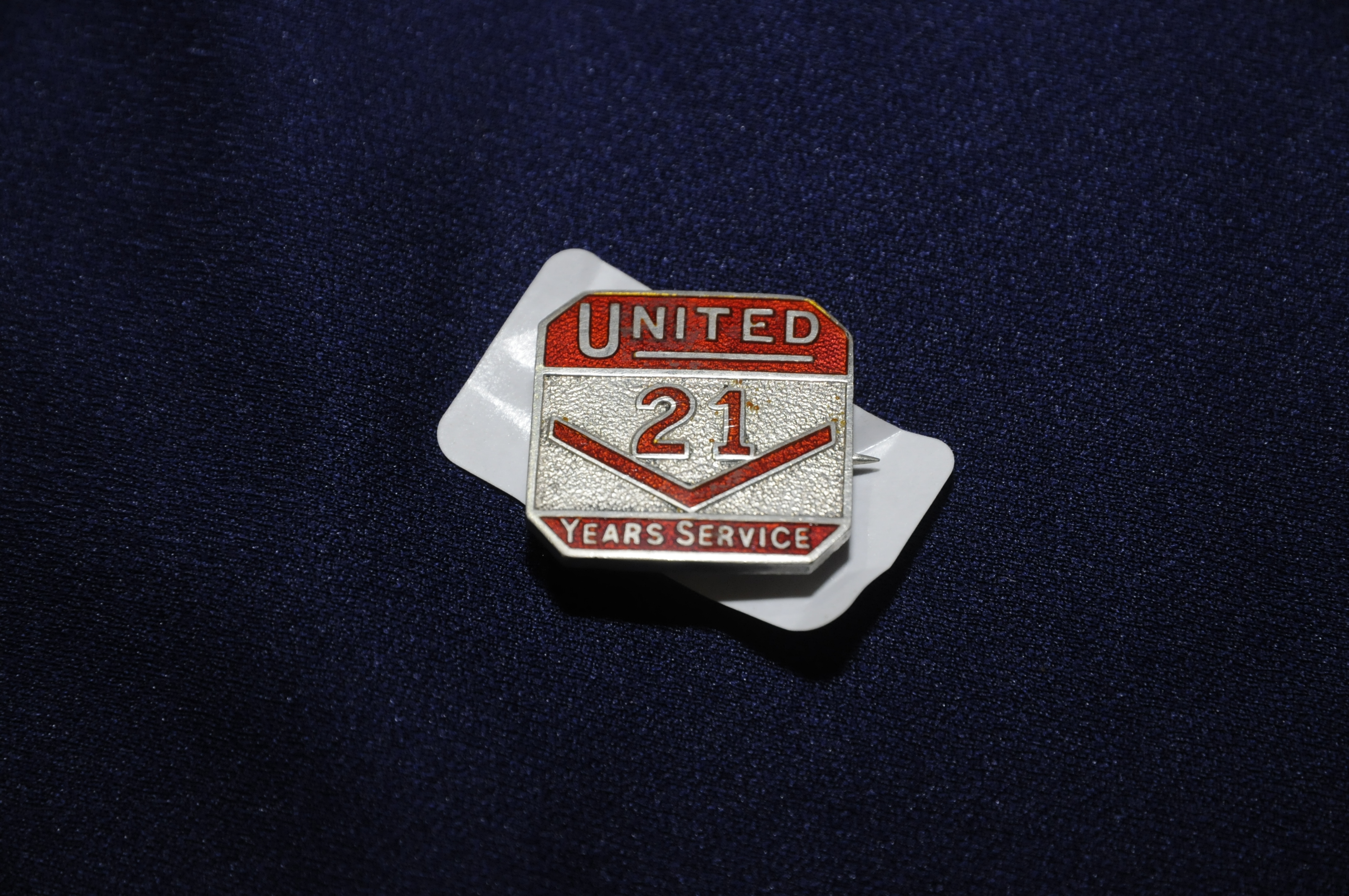 Enamel and silver hallmarked United 21 Years Service lapel badges no.
