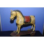 Indian carved wood pull along temple horse with painted detail (65cm high)