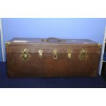 Vintage leather and brass bound canvas travel trunk with central leather strap handle and five