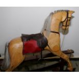 Extremely well crafted carved wood rocking horse with various accessories