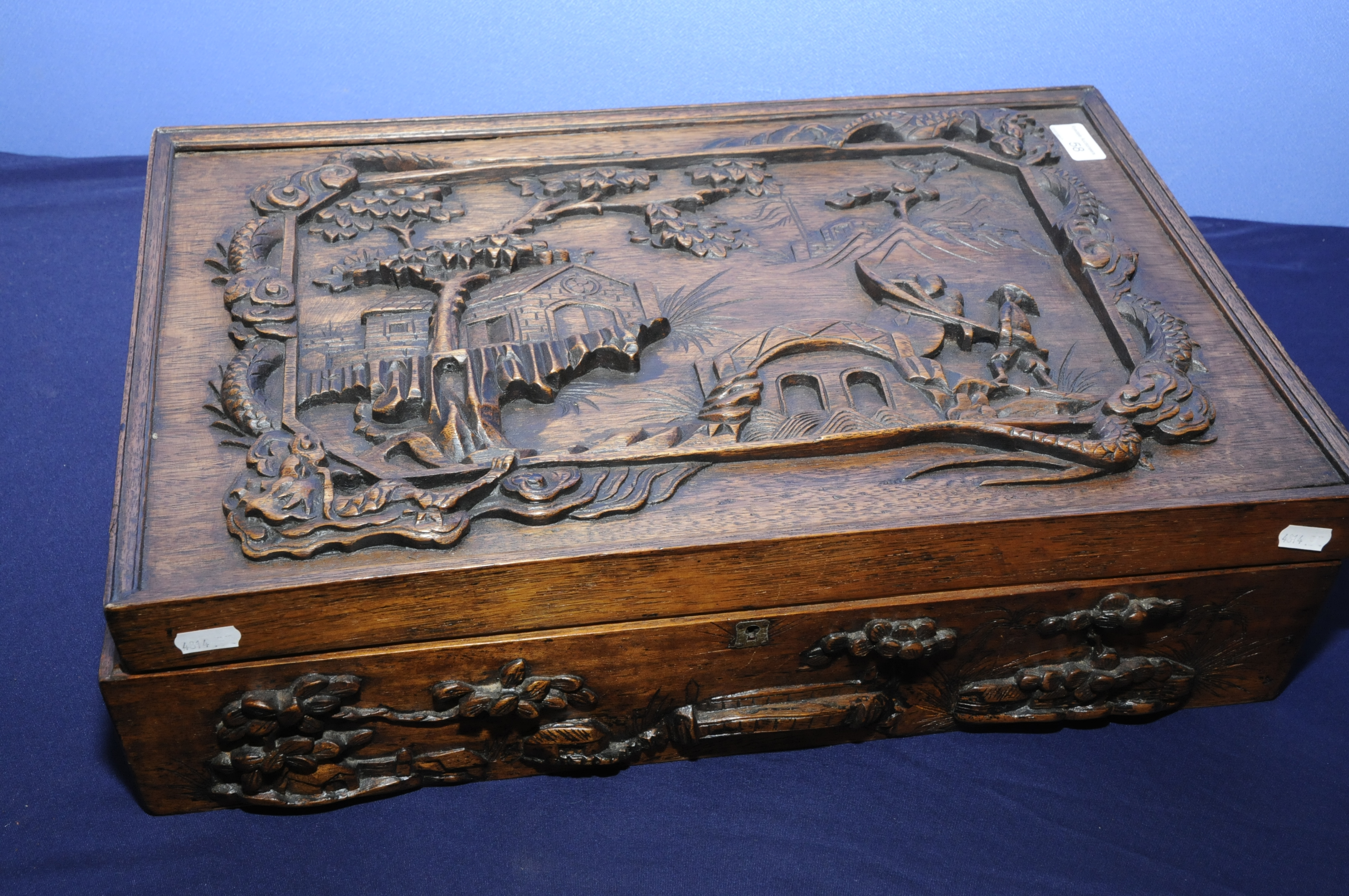 Extremely well carved Chinese wooden hardwood box of rectangular form depicting Chinese life in the