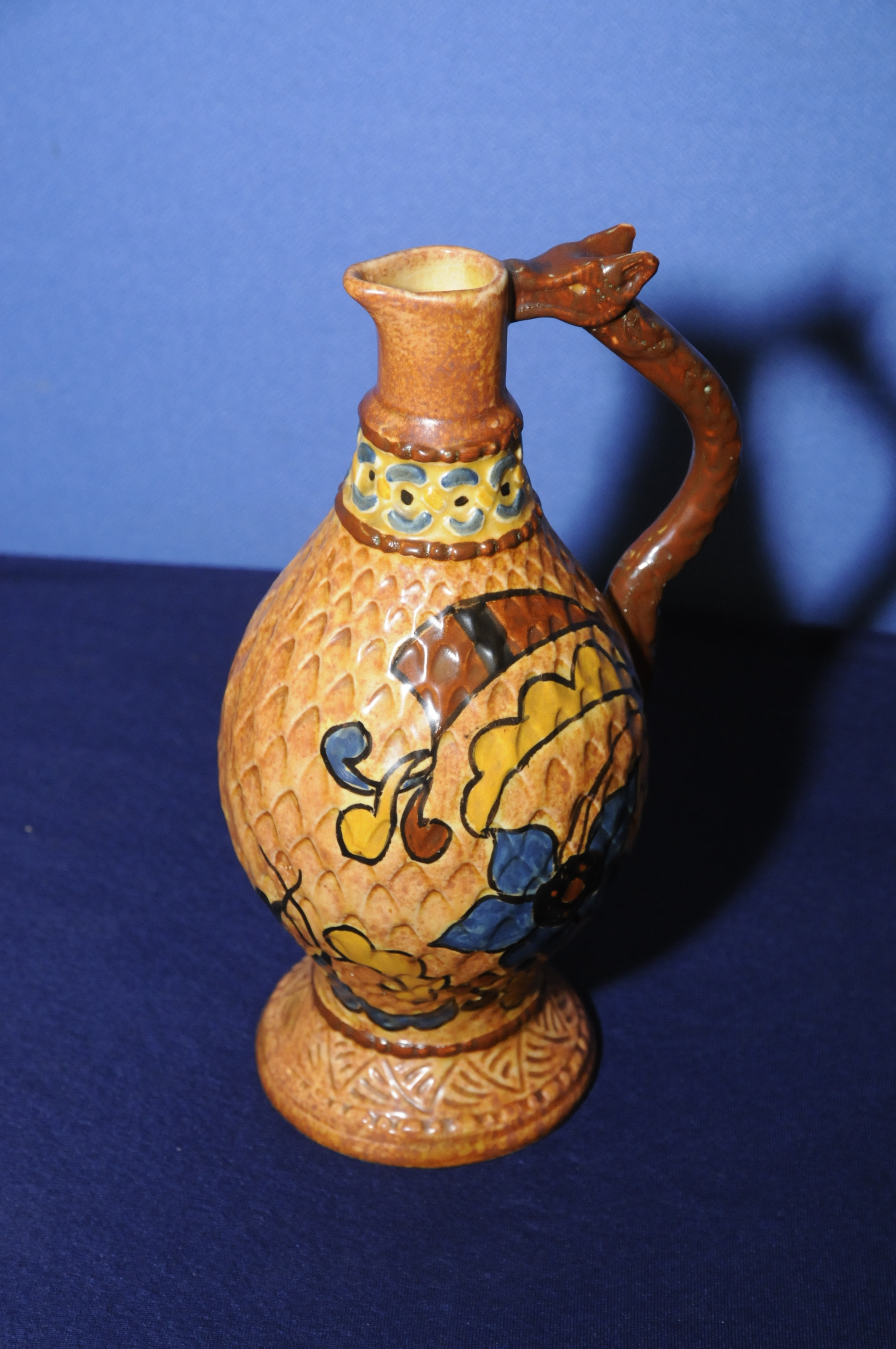 Chameleon Ware jug with dragon handle, (23.5cm high), the base marked No.