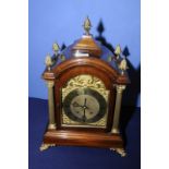 Elaborate mahogany and gilt cased bracket clock with engraved brass dial flanked by a pair of gilt