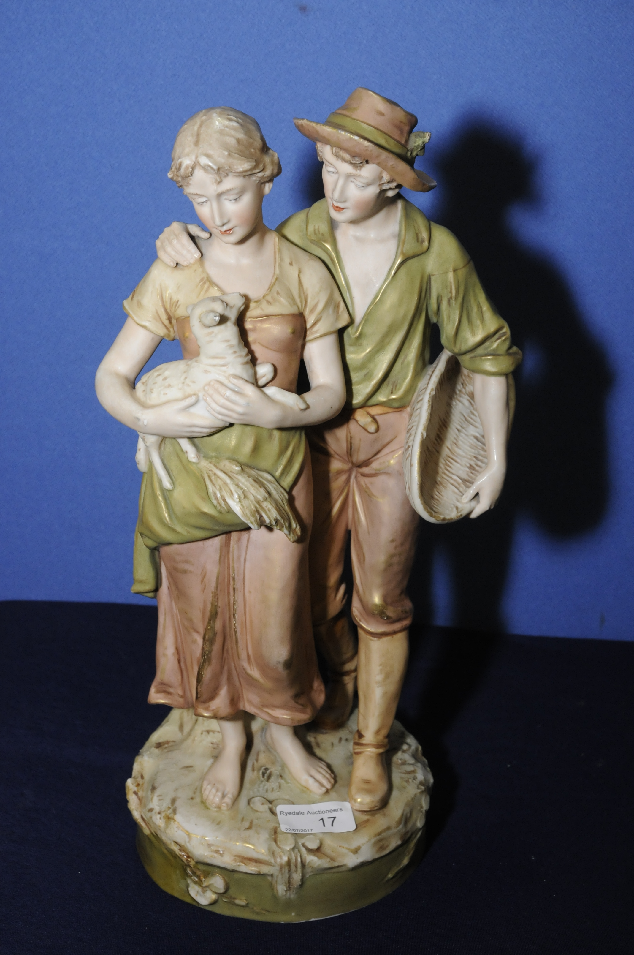 Large Royal Dux figural group depicting courting couple the lady carrying a lamb and the man with a