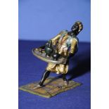 Cold painted bronze Gerschutzt figure of an Arab carrying a serving tray on rug with impressed