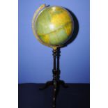 World globe mounted on turned mahogany stand with three out splayed supports (86cm high)