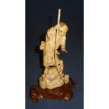Late 19th C Chinese carved ivory figure of a fisherman stood upon rocks with his catch mounted on