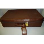 Leather suitcase with zip and strap fastening and makers label Norris England