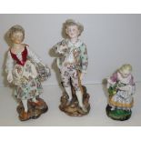 Pair of 19th C figurines in floral print clothes the man is holding a staff and smelling a rose and