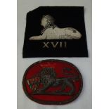 Large oval cloth and gilt wire work embroidered military badge and another