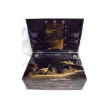 Early 20th C Japanese lacquered writing box the rectangular hinged lid with gilt and red lacquer