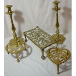 Pair of large brass candlesticks on hexagonal stepped bases and three brass trivets (largest trivet