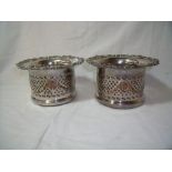 Pair of silver plated bottle coasters with pierced fret work detail and turned wood bases (height