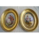 Pair of 19th C continental gilt framed porcelain panels depicting courting couple and two young