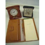 Cased Enicar travelling clock and another similar Vertex travelling clock in leather case with
