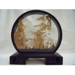 Carved Chinese cork carving of a building in naturalistic setting in ebonised frame (height 18cm)