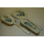 Three piece silver plated and enamelled dressing table set with floral detail