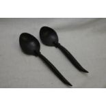 Pair of similar native style spoons,