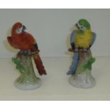 Pair of Sitzendorf parrot figurines on tree trunk bases (one a/f)