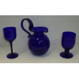 Bristol Blue ovoid jug with looped handle and two Bristol Blue stemmed goblets all with engraved