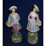 Pair of Staffordshire style figurines of a couple apple picking (height 23cm)