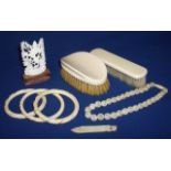 Three carved ivory bangles, delicate simulated ivory bead necklace,