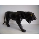 Black leather figure of a panther with inset glass eyes (17cm high)