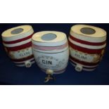 Three stoneware spirit flasks two x Gin and Rum (one with brass tap) (height 29cm,