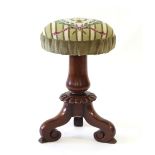 Property of a lady - a Victorian mahogany revolving piano stool with needlework upholstered seat, on