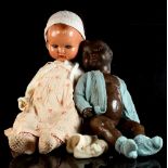 Property of a gentleman - a coloured bisque head doll, stamped 247-4 Germany, 21ins. (53.5cms.)
