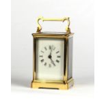 Property of a gentleman - a late 19th / early 20th century brass corniche cased carriage clock,
