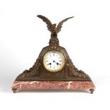 Property of a gentleman - a late 19th century French rouge marble & spelter mantel clock, surmounted