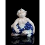 Property of a gentleman - a Royal Copenhagen porcelain model of a faun with grapes, model number