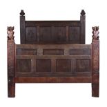 Property of a lady - an interesting carved oak double bedstead, the headboard carved with the