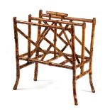 A late 19th / early 20th century bamboo two-section canterbury or magazine rack, with gilt metal