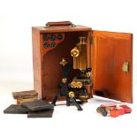 Property of a gentleman - an early 20th century lacquered brass & blacked microscope, by Watson &