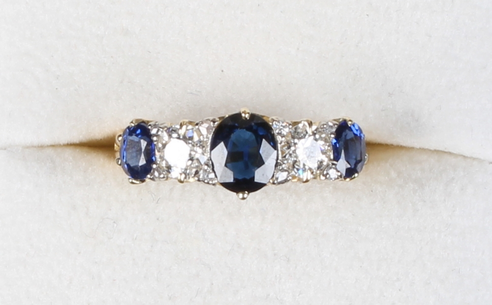 An 18ct yellow gold sapphire & diamond five stone ring, the central sapphire weighing