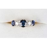 An 18ct yellow gold sapphire & diamond five stone ring, the central sapphire weighing