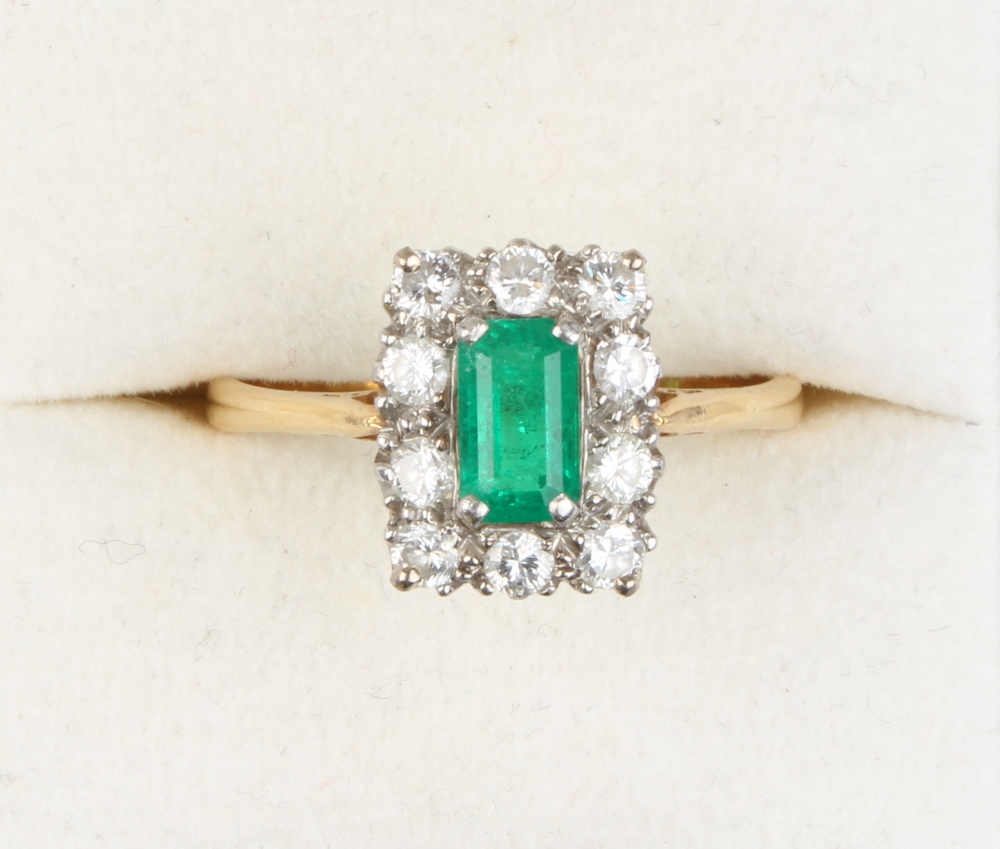 Property of a lady - a yellow gold emerald & diamond ring, the rectangular cut emerald measuring
