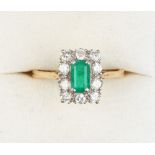 Property of a lady - a yellow gold emerald & diamond ring, the rectangular cut emerald measuring