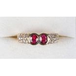 A Gubelin 18ct yellow gold ruby & diamond ring, the two collet set oval cut rubies flanked by pave