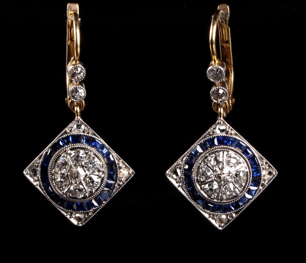 A pair of sapphire & diamond pendant earrings, each with a square panel set with a ring of calibre