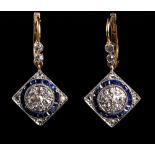 A pair of sapphire & diamond pendant earrings, each with a square panel set with a ring of calibre