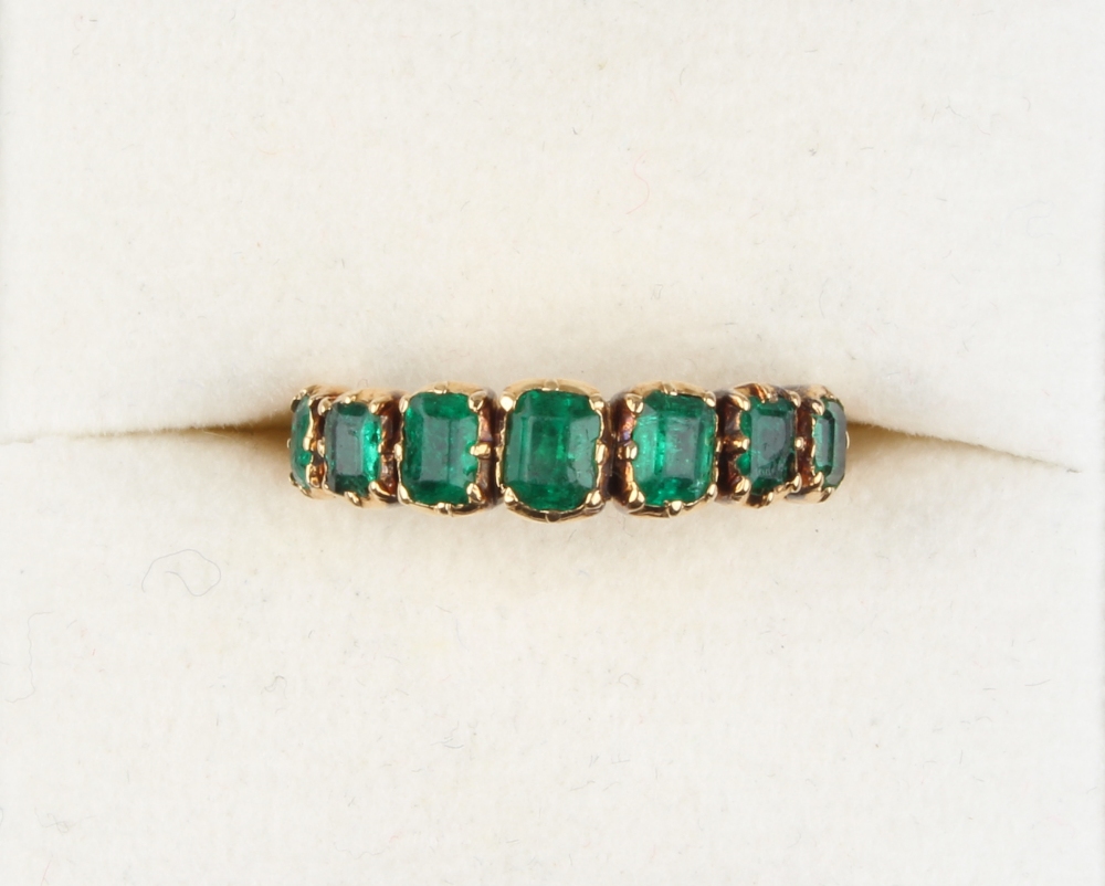 Property of a lady - a Georgian yellow gold emerald seven stone ring, the rectangular cut stones