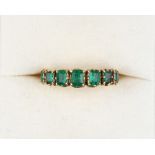 Property of a lady - a Georgian yellow gold emerald seven stone ring, the rectangular cut stones