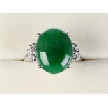 A white gold jadeite & diamond ring, the untreated oval cabochon jadeite panel weighing 9.71 carats,