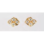 A pair of Cartier 18ct yellow gold diamond flowerhead earrings, each set with four diamonds,