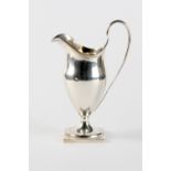 Property of a gentleman - a George III silver helmet cream jug, with square base, makers James