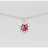 A white gold ruby & diamond cluster pendant, with central cut ruby set within a border of eight